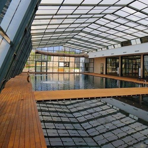 Hohe Schwimmbadüberdachung - EVOLUTION LEAN-TO - Evergreen Solutions - für Wandmontage / einziehbar / Aluminium