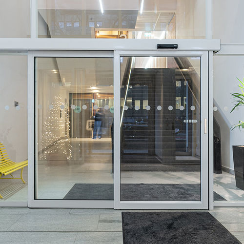 Aluminium-Schiebesystem - SL521 Telescopic - ASSA ABLOY Entrance Systems - Glastüren / mit versteckten Laufrollen / für Gewerbegebrauch