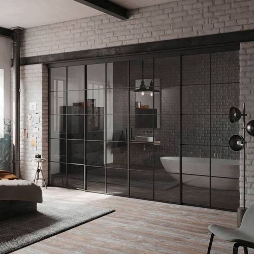 Festinstallierte Trennwand - GRUPO STYLO INTERIORISMO SL - Schiebe / Metall / Glas
